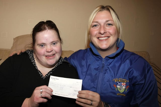 GATEWAY CHEQUE. Kellyanne Allen (right) from Glebe Rangers FC Supporter's Club, pictured presenting a donation to Hayley Allen, who was accepting it on behalf of Ballymoney Gateway Club. The presentation took place on Wednesday night at Hayley's home.BM50-015SC.