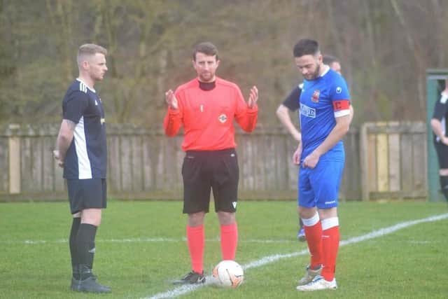 The captains of Scarva Rangers and Glenavy Youth chat with the referee