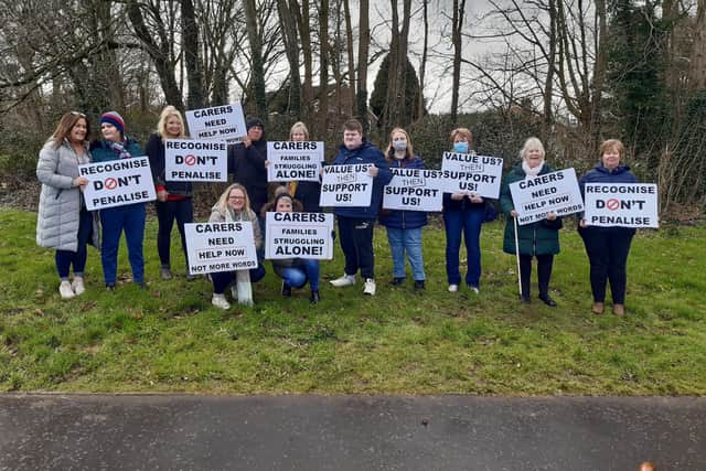 Carers of adults with learning disabilities stage a protest at the Southern Health Trust Headquarters near Craigavon Hospital on Monday.
