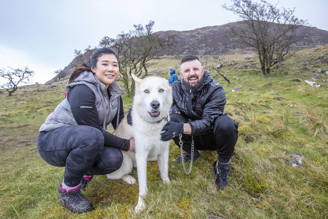 Aidan Malone and Lindsay Tsang with dog KAI, after completing the St Patricks Day climb on Slemish mountain in Co Antrim.Photo Paul Faith