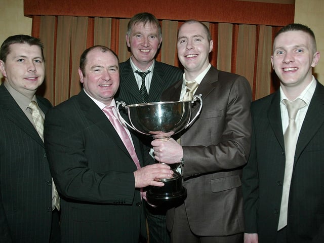 Ballinderry Senior Player of the Year Michael Conlon receives his award from Karl Conlon Senior Team Manager. Also pictured are Joe Canavan ( Team Manager ), Martin Mc Kinless ( Team Manager ) and Gerry Mc Cusker ( Team Manager).