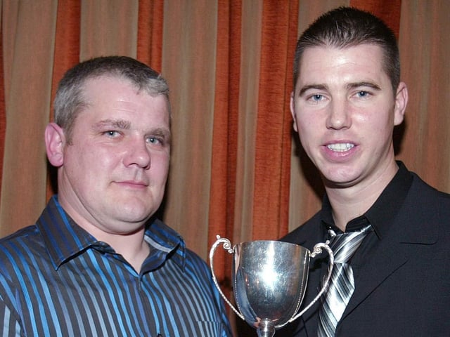 Dominic Rocks presents the reserve Championship Trophy to team captain Cathal Cassidy.