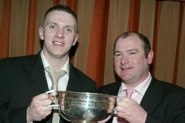Karl Conlon, Captain of Ballinderry Shamrock, receives the Derry Championship Trophy from Martin McKinless at the awards night in 2007.