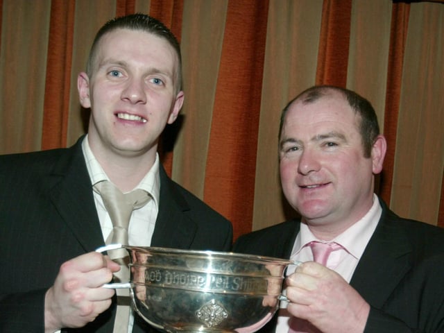 Karl Conlon, Captain of Ballinderry Shamrock, receives the Derry Championship Trophy from Martin McKinless at the awards night in 2007.