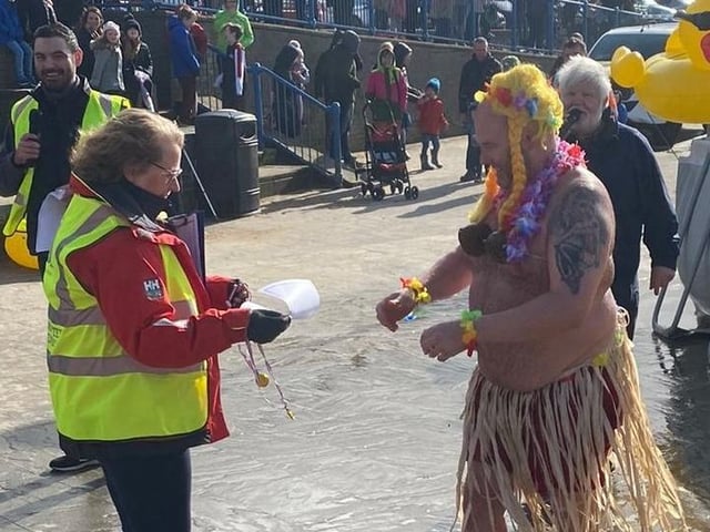 A brave Duck Diver receives his/her medal for taking part