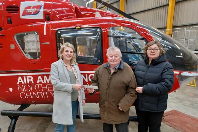 Nan’s husband Rodger and daughter-in-law Catherine make the donation of £1625 to Air Ambulance NI
