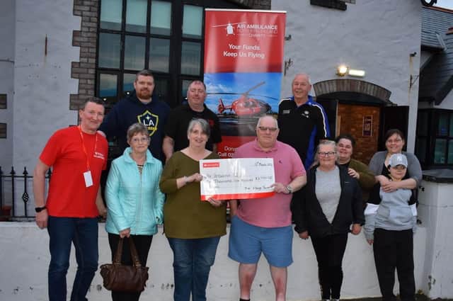 Air Ambulance NI volunteer Liam Cunning was presented with a cheque for the charity from The Village Tavern Articlave, proceeds raised at a Darts Tournament organised by owners James and Marion Bowman