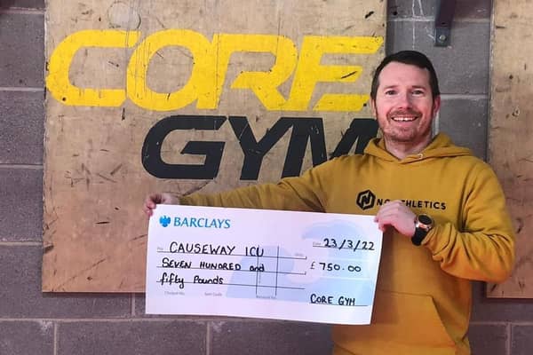 Ciaran White, one of the personal trainers at Core, with the cheque for £750 raised by Core Gym staff and members for the Causeway Hospital ICU as a thank you for their incredible work during the pandemic