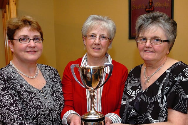 Derryloran Bowling Club ladies pair’s winners Olive Kyle and Iris Ferguson pictured as they receive their award from Mrs Janet Porteus.