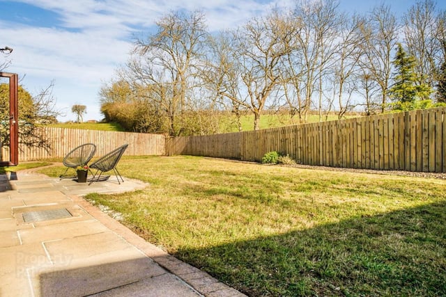 Outdoor features include brick pavia parking area to side and rear - flagged walkway, laid in lawn, enclosed with wooden fencing