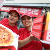 Apache Pizza is creating 400 new jobs with the opening of 20 new stores in Northern Ireland following a 32 percent increase in online pizza sales. Pictured celebrating the announcement are in-store team members, Neeyati Vaghela and Luciana Matos.  Pic Julien Behal Photography
