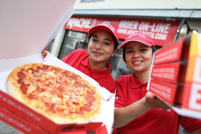 Apache Pizza is creating 400 new jobs with the opening of 20 new stores in Northern Ireland following a 32 percent increase in online pizza sales. Pictured celebrating the announcement are in-store team members, Neeyati Vaghela and Luciana Matos. Pic Julien Behal Photography