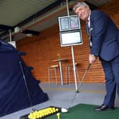 The Mayor of Antrim and Newtownabbey, Cllr Billy Webb takes a swing using Toptracer at Ballyearl Driving Range.