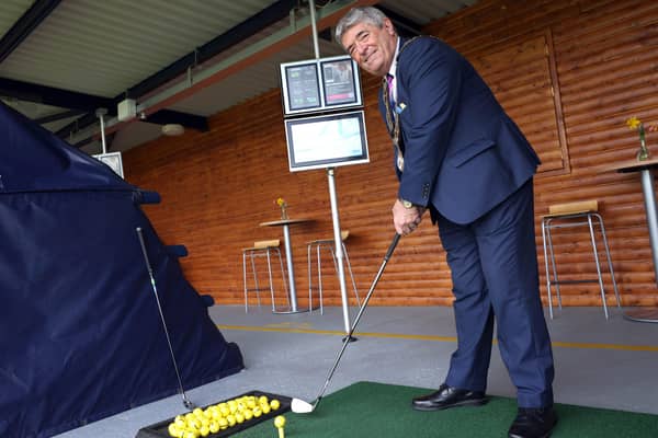 The Mayor of Antrim and Newtownabbey, Cllr Billy Webb takes a swing using Toptracer at Ballyearl Driving Range.