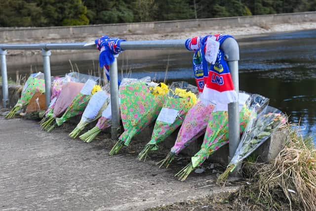 Flowers laid at the scene where the the body of Roy Reynolds was found at Woodburn Reservoir in Carrickfergus. Picture: Kirth Ferris /Pacemaker Press