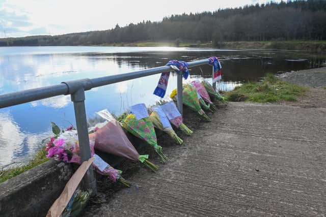 Flowers laid at the scene where the the body of Roy Reynolds was found at Woodburn Reservoir in Carrickfergus.  Picture: Pacemaker Press