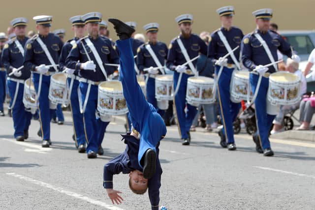 An acrobatic display from the young leader of the Constable Anderson Memorial Band during the Twelfth demonstration in Larne in 2021. Picture: Stephen Davison.