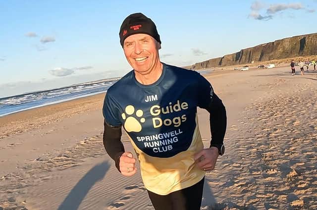 Jim modelling his running top from Guide Dogs Northern Ireland