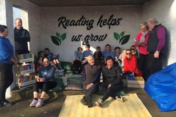 Parents and pupils in the new outdoor reading area.