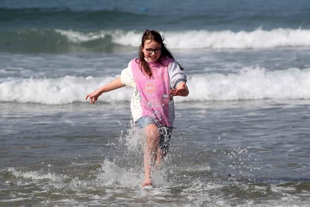 Enjoying the waves on Portrush West Strand. Picture: PressEye