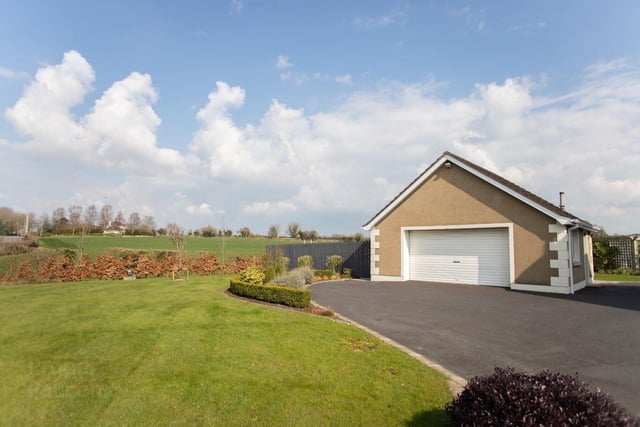 The detached double garage and tarmac driveway with parking areas for numerous vehicles.