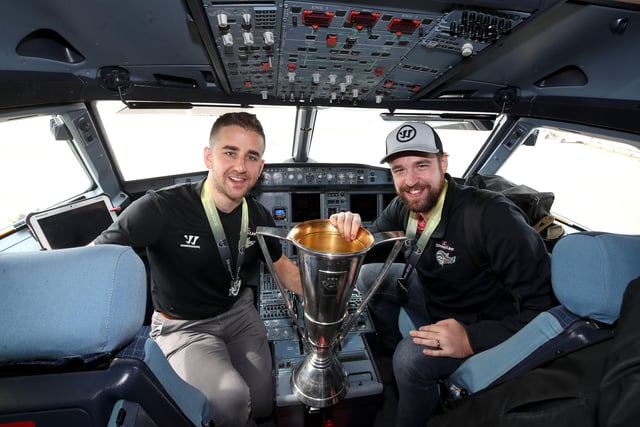 The Belfast Giants' David Goodwin and Tyler Beskorowany in the cockpit of the plane as they arrive at Belfast International Airport today after being crowned Premier Sports Elite League champions after defeating Sheffield Steelers yesterday. Pictured with the Elite League Trophy are   Photo by William Cherry/Presseye