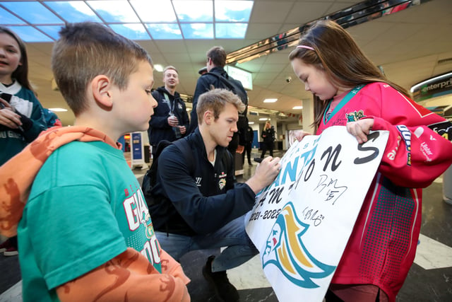 Belfast Giants' Griffin Reinhart signs his autograph for fans as they arrive at Belfast International Airport today after being crowned Premier Sports Elite League champions after defeating Sheffield Steelers yesterday.    Photo by William Cherry/Presseye