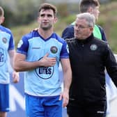 Warrenpoint Town first-team coach John Gill (right) and players following Saturday's Danske Bank Premiership win over Portadown.