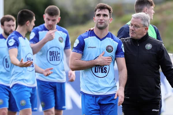 Warrenpoint Town first-team coach John Gill (right) and players following Saturday's Danske Bank Premiership win over Portadown.