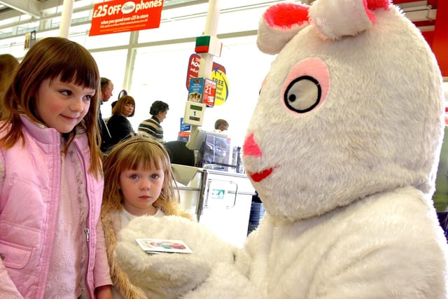 The Easter Bunny who made a special appearance at Tesco Cookstown in 2007 hands out treats to two young shoppers.