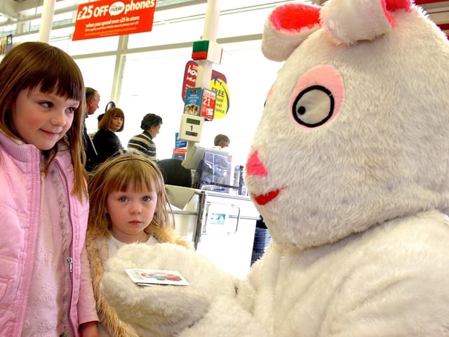The Easter Bunny who made a special appearance at Tesco Cookstown in 2007 hands out treats to two young shoppers.