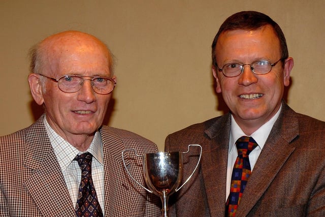 James Rippey hands over the Derryloran Parish Church Bowling Club men’s singles runner-up trophy to Gordon Johnston.