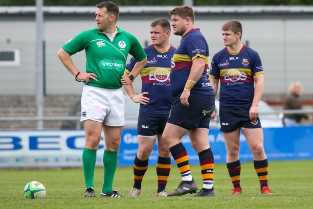 Brothers-in-arms - Peter, Michael and Josh Cromie in conversation with the referee during Bann's game at Navan