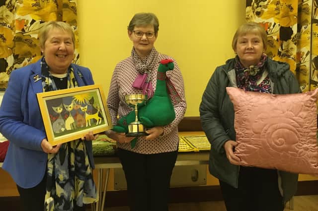 Liz Barry, Betty Graham and Sharon Moon proudly display the Greenisland Cup along with some of their craftwork