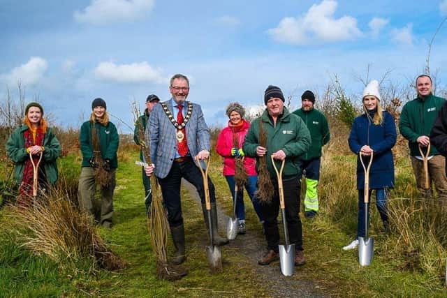 Mayor of Mid and East Antrim, Councillor William McCaughey, Paul Armstrong from the Woodland Trust and MEA Parks & Open Spaces staff planting the 58,000th tree.