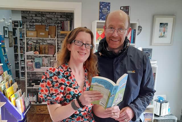 Holly and Paul Crawford with their book in The Secret Bookshelf, Carrickfergus.