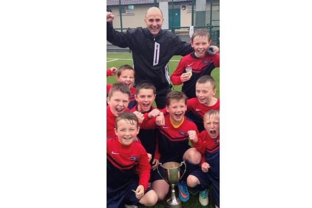 Derby County player Darren Robinson with his former teacher Stephen Blevins and team mates from Orchard County Primary School in Portadown.