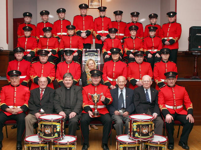 Members of the Churchill Flute Band, pictured at the dedication and presentation of a band cup in memory of band member Drew Porter, held in the Apprentice Boys Memorial Hall, Londonderry. Included seated (second from left) are Derek Nutt, band chairman, the Dean of Derry Very Rev. William Morton, Simon Mowbray, bandmaster, Walter McLaughlin, president and James Thompson, vice-chairman. INLS 1214-515MT.
