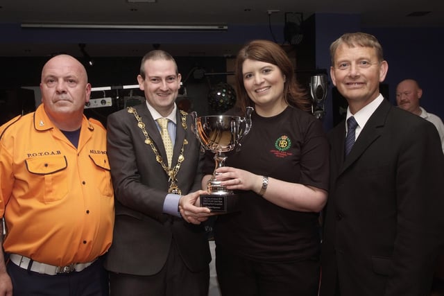 The Mayor, Councillor Martin Reilly, pictured presenting the Best Style & Appearance Cup to Wendy Wilson, of the Churchill Flute Band, at the presentation ceremony held in Rochesters for the Marching Bands Competition which took place in Ebrington Square. Included are Alderman Maurice Devenney, right, and Geoff Cruickshank, of the Pride of the Orange & Blue Auld Boys, organisers of the event. INLS4113-109KM