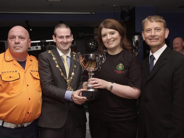 The Mayor, Councillor Martin Reilly, pictured presenting the Best Style & Appearance Cup to Wendy Wilson, of the Churchill Flute Band, at the presentation ceremony held in Rochesters for the Marching Bands Competition which took place in Ebrington Square. Included are Alderman Maurice Devenney, right, and Geoff Cruickshank, of the Pride of the Orange & Blue Auld Boys, organisers of the event. INLS4113-109KM