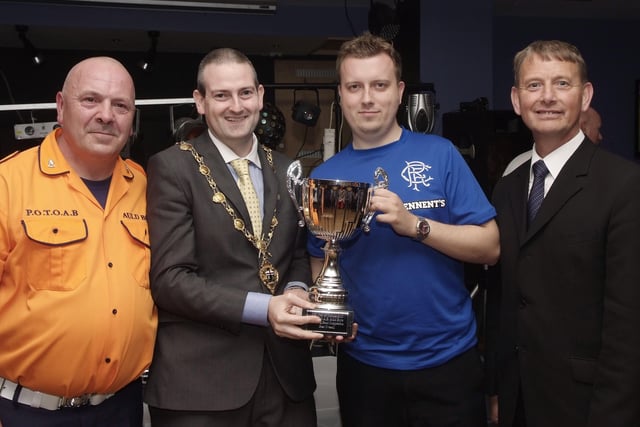 The Mayor, Councillor Martin Reilly, pictured presenting the Best Overall Band Cup to Gordon Porter, of the Churchill Flute Band, at the presentation ceremony held in Rochesters for the Marching Bands Competition which took place in Ebrington Square. Included are Alderman Maurice Devenney, right, and Geoff Cruickshank, of the Pride of the Orange & Blue Auld Boys, organisers of the event. INLS4113-111KM