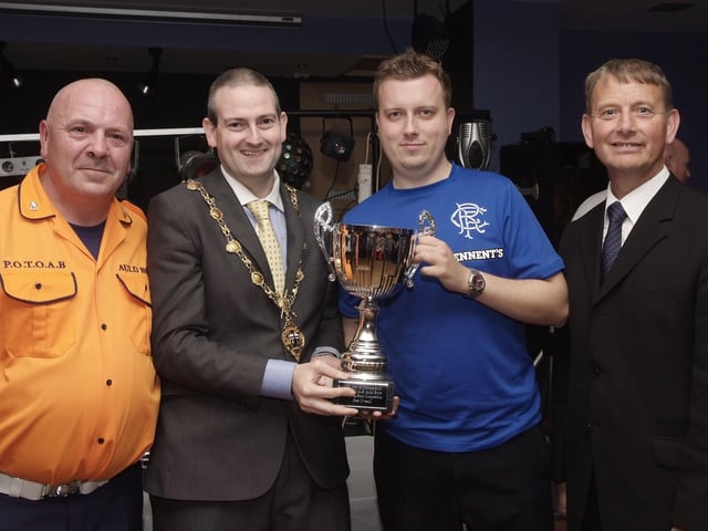 The Mayor, Councillor Martin Reilly, pictured presenting the Best Overall Band Cup to Gordon Porter, of the Churchill Flute Band, at the presentation ceremony held in Rochesters for the Marching Bands Competition which took place in Ebrington Square. Included are Alderman Maurice Devenney, right, and Geoff Cruickshank, of the Pride of the Orange & Blue Auld Boys, organisers of the event. INLS4113-111KM