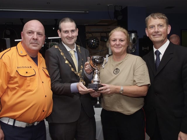 The Mayor, Councillor Martin Reilly, pictured presenting the Best Melody/Part Music Cup to Janice Channing, of the Churchill Flute Band, at the presentation ceremony held in Rochesters for the Marching Bands Competition which took place in Ebrington Square. Included are Alderman Maurice Devenney, right, and Geoff Cruickshank, of the Pride of the Orange & Blue Auld Boys, organisers of the event. INLS4113-107KM