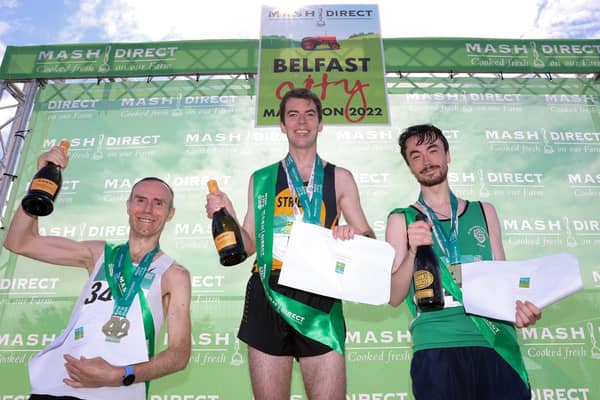 The overall podium for the Mash Direct Belfast City Marathon was made up of Gary O'Hanlon (left - 3rd with a time of 2.26.59), Conor Gallagher (right - 2nd with a time of 2.24.59) and winner, Paul Pollock with a time of 2.16.13. Picture: Philip Magowan / PressEye