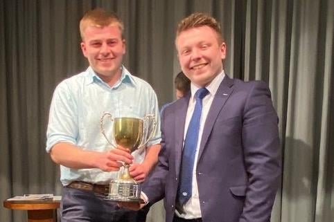 Club member James Currie receiving the Junior Ulster Young Farmer Trophy