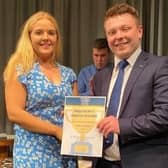 Club Secretary Erinn Ramsay receiving her President’s Award Certificate from Adam Alexander