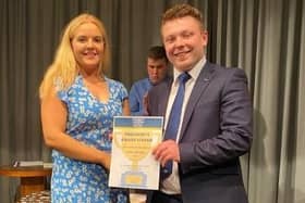 Club Secretary Erinn Ramsay receiving her President’s Award Certificate from Adam Alexander