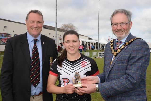 The Mayor, Cllr William McCaughey and Michael Simms, president of Carrick RFC, presenting Tia Maguire from Cooke with the Player of the Tournament award in the Mid & East Antrim Borough Council sponsored competition.