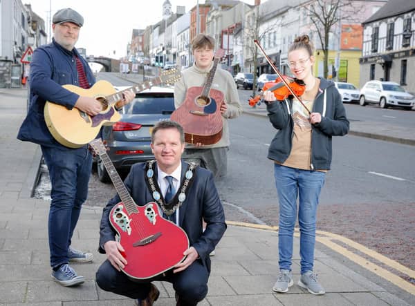 Lord Mayor Glenn Barr and BBC Radio Ulster's Ralph McLean with young buskers in Banbridge ahead of the return of Buskfest on May 21