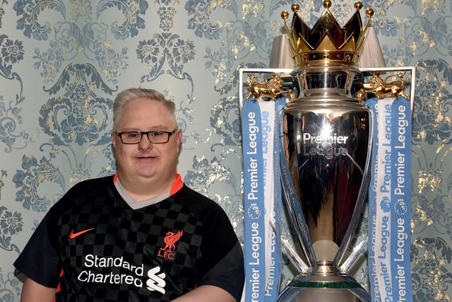 Well known local Liverpool supporter, Barry Watson, poses with the EPL Trophy at Charlie McKeever's Bar last week. INPT18-204.